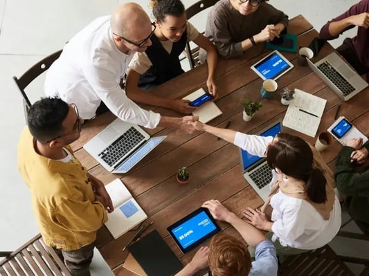 group-working-on-laptops-at-table